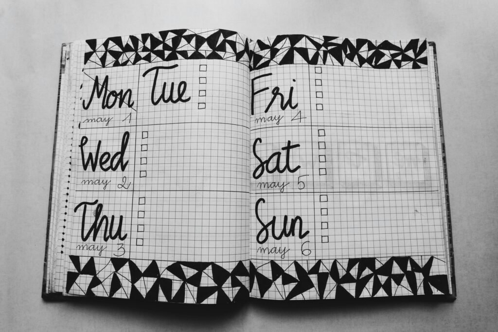 Monochrome weekly planner featuring hand-drawn geometric patterns and days of the week.